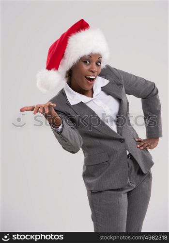 Smiling african Santa Girl presenting your product, lots of copyspace