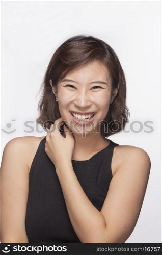 Smiling and happy young woman, portrait, studio shot