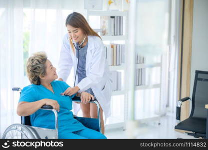 Smiling and talking, caregiver smiling and talking to aged woman while taking care of her