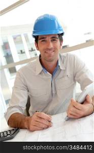 Smiling architect in office working with electronic tablet