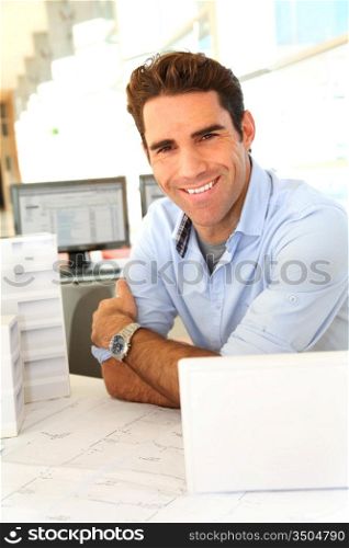 Smiling architect sitting in office