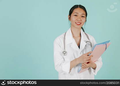 smiling asian doctor with stethoscope folder