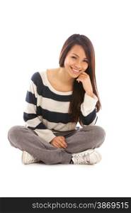 Smiling asian girl sitting on the floor over white isolated background