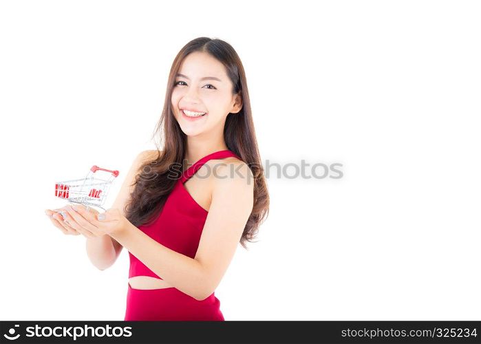 Smiling asian woman in red dress holding shopping cart with girl isolated on white background, shopping online concept.