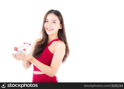 Smiling asian woman in red dress holding shopping cart with girl isolated on white background, shopping online concept.