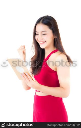 Smiling asian woman in red dress using tablet with glad, girl looking and holding tablet isolated on white background