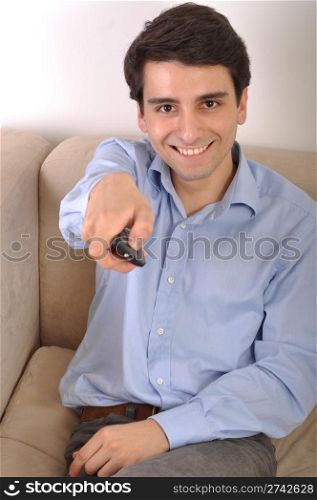 smiling attractive young man watching televison