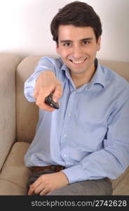 smiling attractive young man watching televison