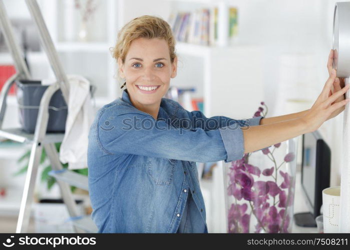 smiling attractive young women having fun wall painting