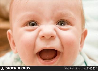 Smiling baby boy closeup portrait with soft focus