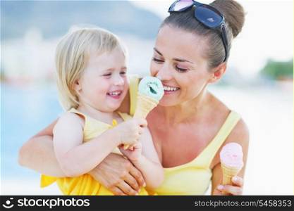 Smiling baby giving mother ice cream