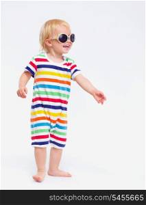 Smiling baby in swimsuit and sunglasses looking on copy space