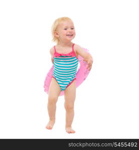 Smiling baby in swimsuit with inflatable ring