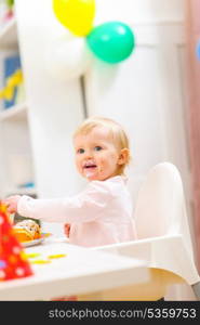 Smiling baby on first birthday celebration