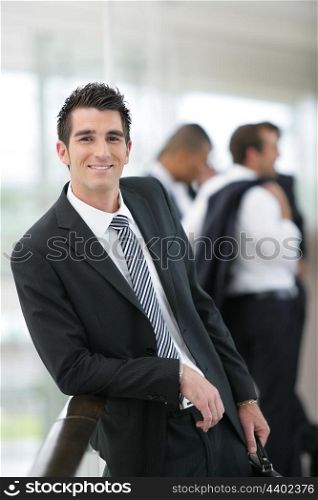 Smiling banker standing in a hall