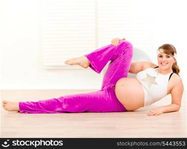 Smiling beautiful pregnant woman doing aerobics exercise aerobics at home&#xA;
