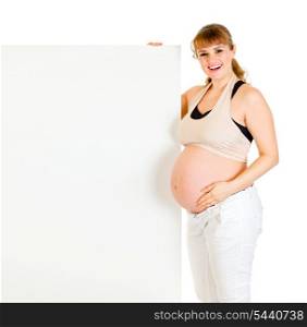 Smiling beautiful pregnant woman holding blank billboard isolated on white&#xA;