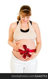 Smiling beautiful pregnant woman holding her belly with red ribbon on it isolated on white&#xA;