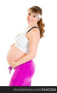 Smiling beautiful pregnant woman in sportswear holding her belly isolated on white&#xA;