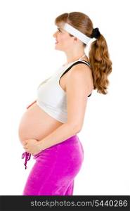 Smiling beautiful pregnant woman in sportswear holding her belly isolated on white&#xA;