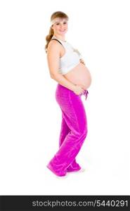 Smiling beautiful pregnant woman in sportswear holding her tummy isolated on white&#xA;