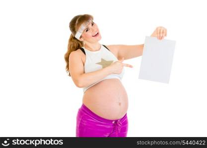 Smiling beautiful pregnant woman pointing finger at empty white paper isolated on white&#xA;