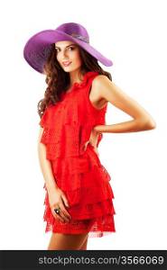 Smiling beautiful woman in red dress and violet hat on white background