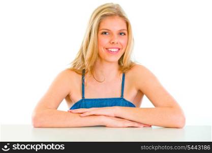 Smiling beautiful young girl sitting at table &#xA;