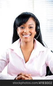 Smiling black customer service and support woman wearing headset