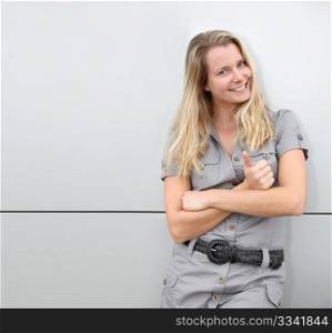 Smiling blond woman on grey background