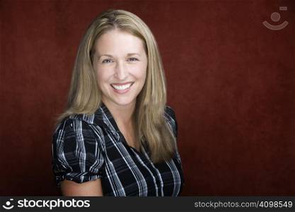 Smiling blonde woman in a studio setting