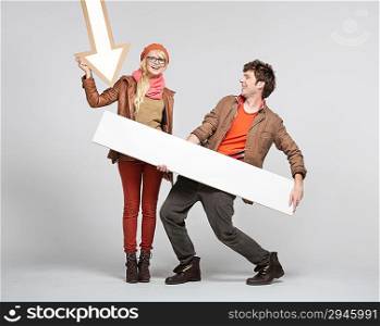 Smiling blonde woman pointing on empty board