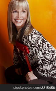 Smiling blonde woman sitting on the chair