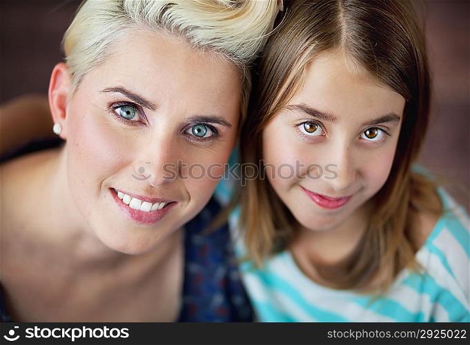 Smiling blonde woman with cute daughter