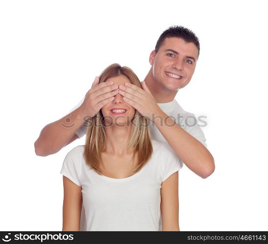 Smiling boy covering his girlfriend's eyes to surprise him isolated on a white background