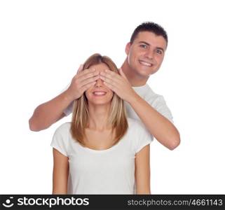 Smiling boy covering his girlfriend's eyes to surprise him isolated on a white background