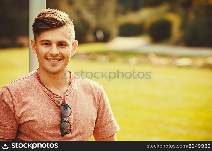 Smiling boy enjoying park. . Handsome masculinity relax concept. Smiling boy enjoying park. Young relaxed man outdoors.