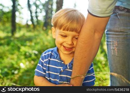 Smiling boy holding father&rsquo;s hand