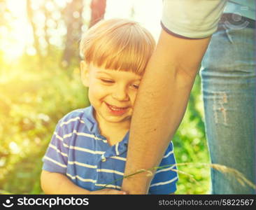 Smiling boy holding father&rsquo;s hand