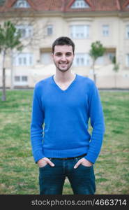 Smiling boy in blue dress with townhouses behind him