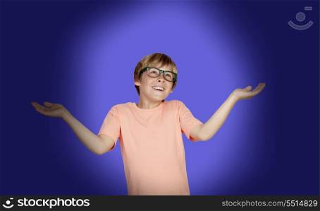 Smiling boy with a doubtful expression on a over blue background