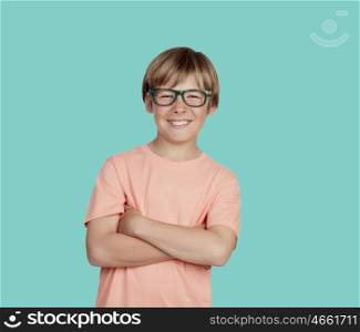 Smiling boy with glasses on a green background