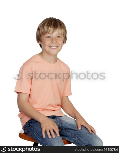 Smiling boy with orange t-shirt sitting isolated on white background