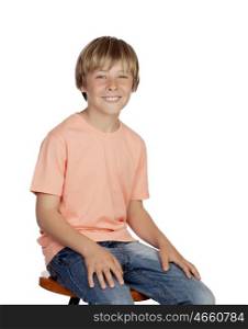 Smiling boy with orange t-shirt sitting isolated on white background