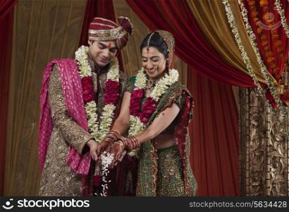 Smiling bride and bridegroom during wedding ceremony