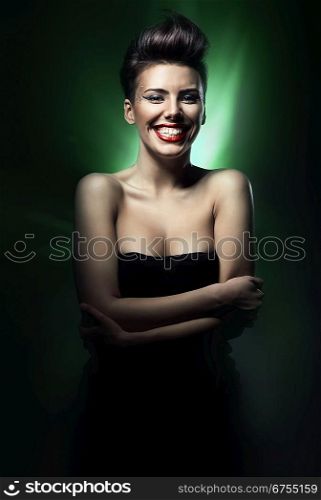 smiling brunette woman with red lips in green light