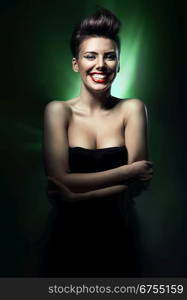 smiling brunette woman with red lips in green light