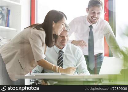 Smiling business people in meeting at office desk