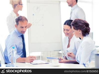 smiling business team discussing something in office. business team discussing something in office