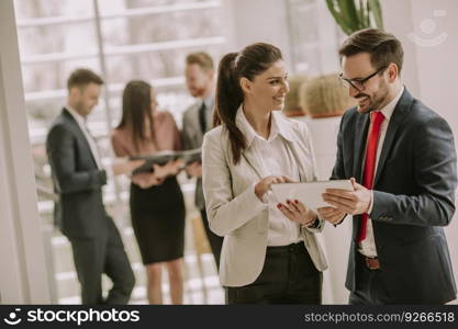 Smiling business team working with digital tablet in the modern office